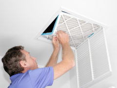 Man Removing Dirty Air Filter - Consign Living